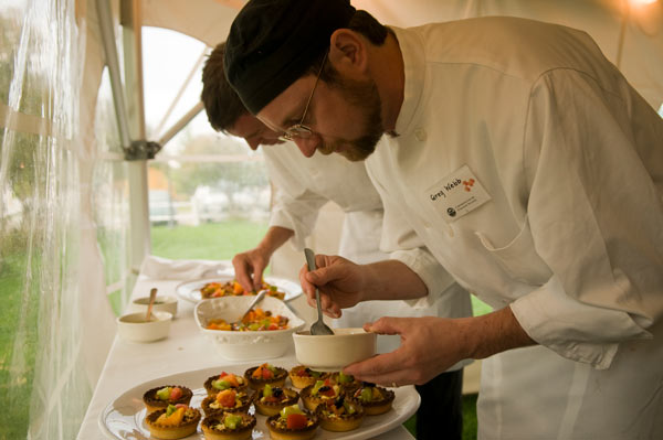 chef dishing appetizers during local food event